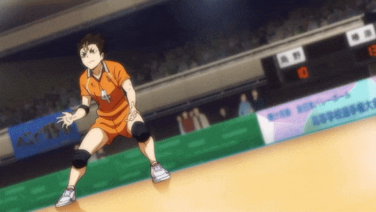 a gif of nishinoya yuu (haikyuu) receiving a ball and rolling on the floor